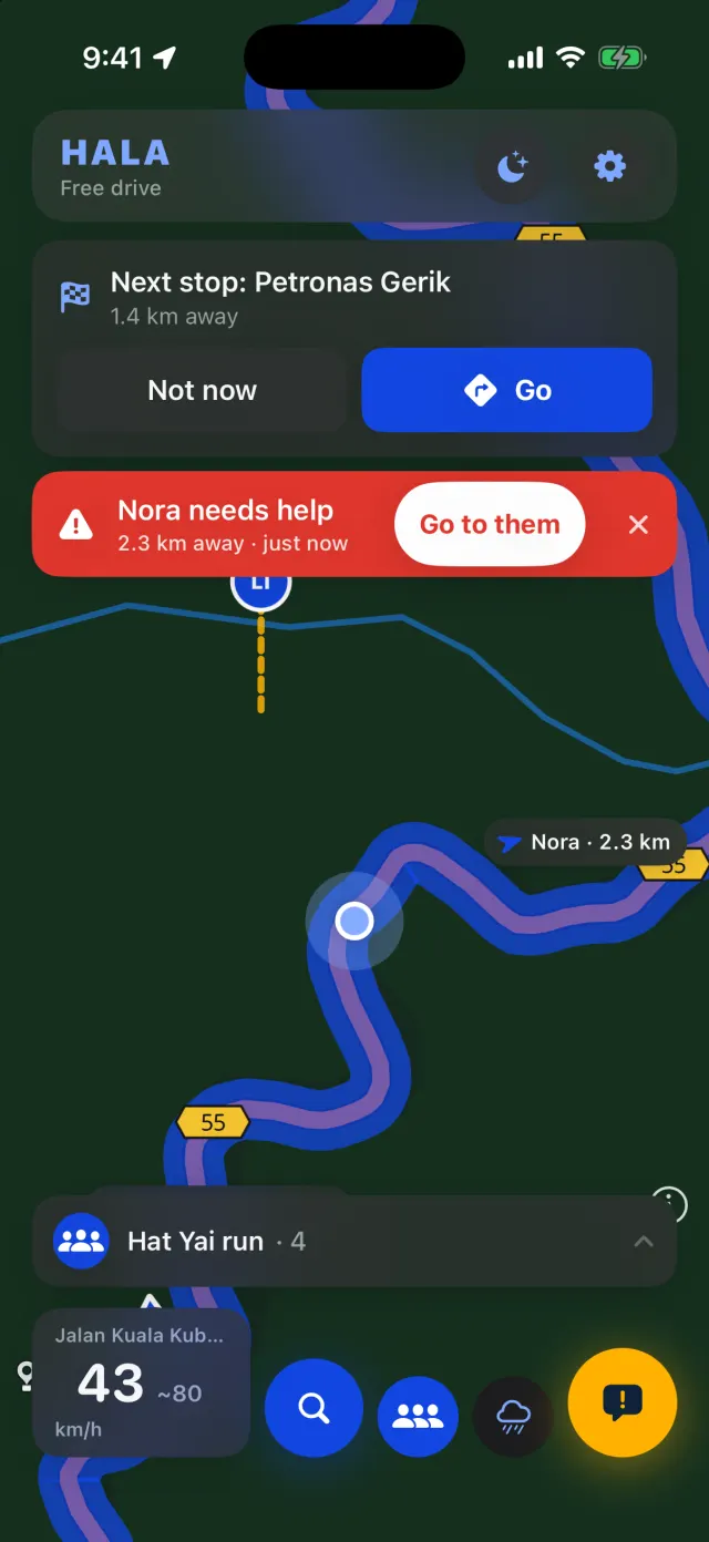 A convoy on the map: a banner says Nora needs help, 2.3 km away, with a Go to them button; the next stop is Petronas Gerik.