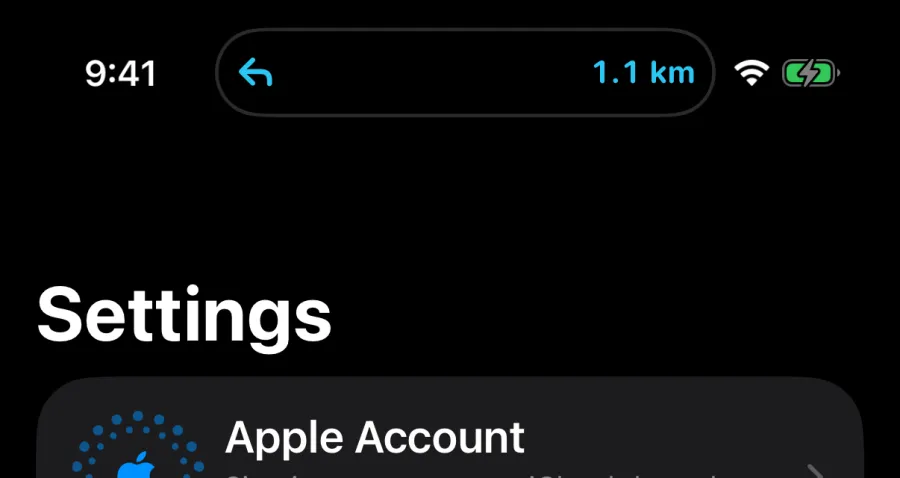 The Dynamic Island showing a left-turn arrow and 1.1 km while another app is open.